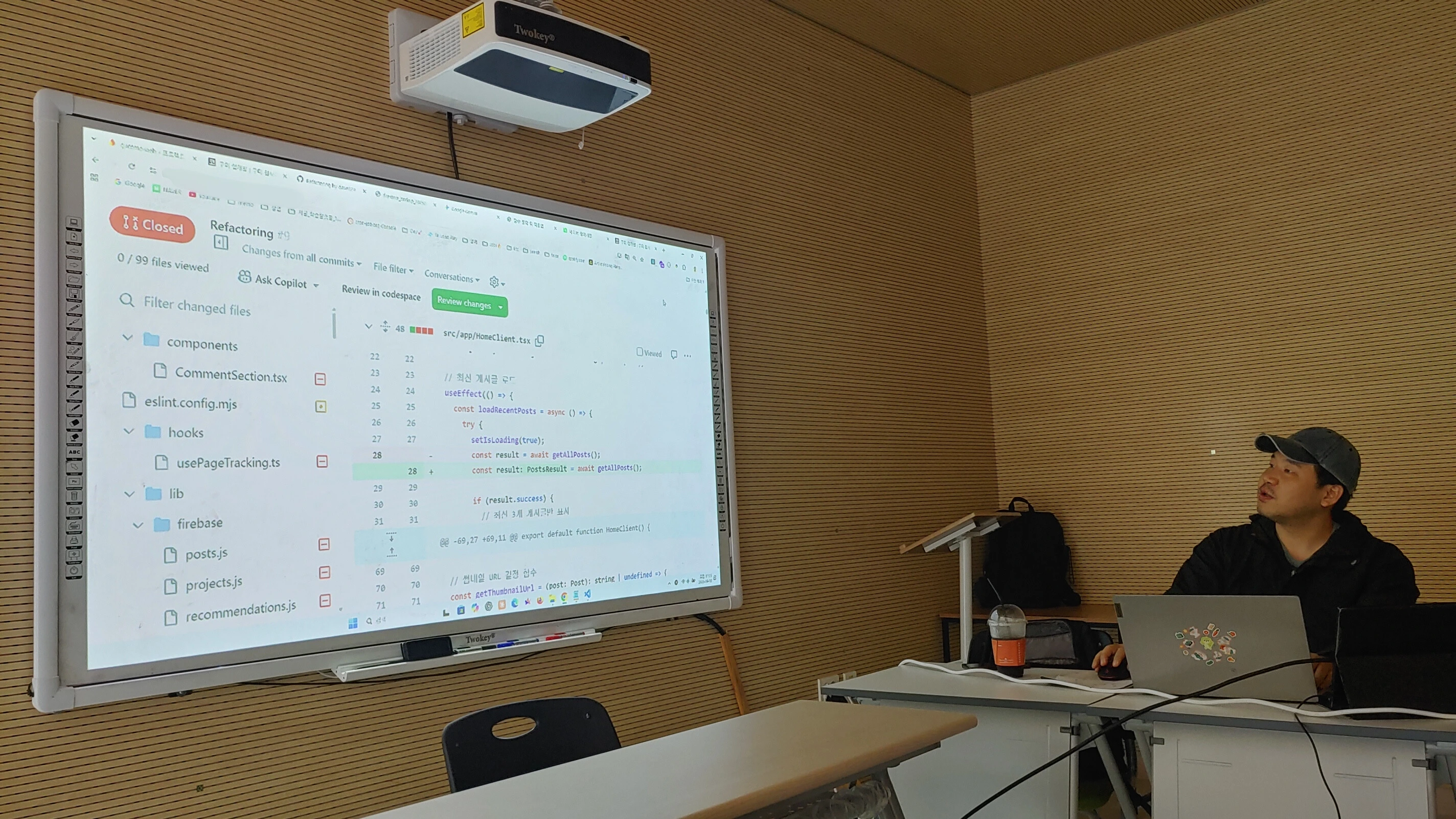 NeonLabs code review session projected on a large display