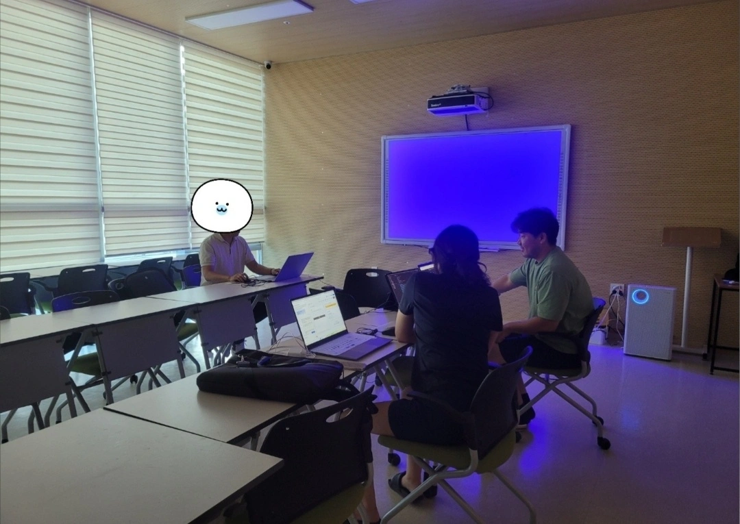 NeonLabs team discussing work around laptops in a meeting room